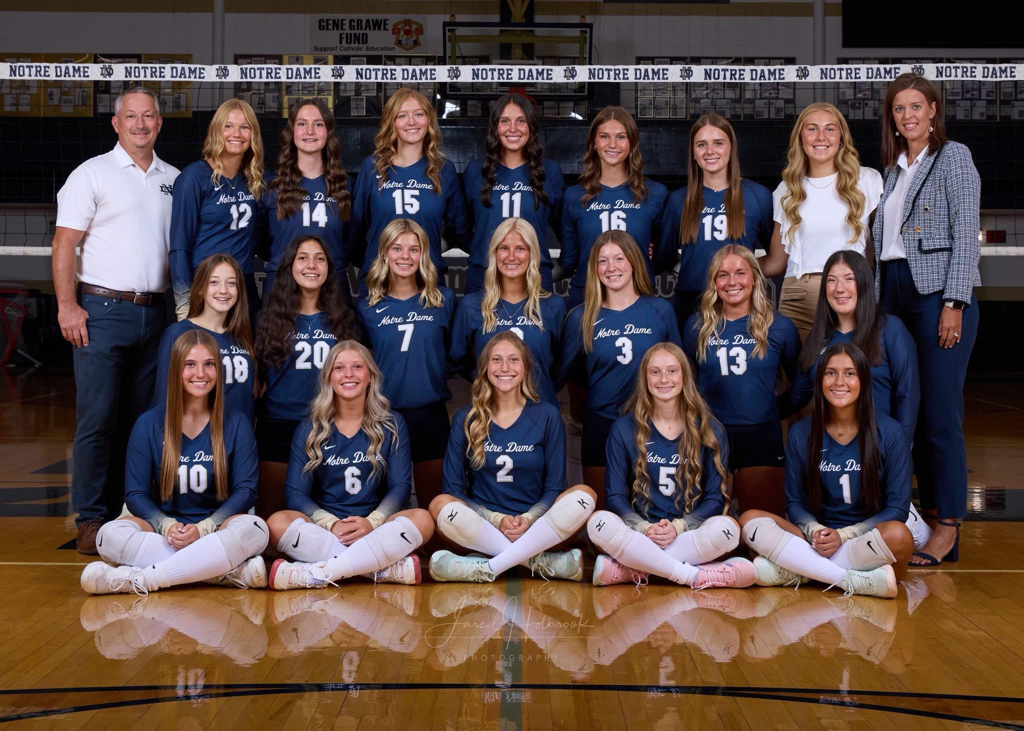 Vball Varsity 2025 Volleyball players pose for photo in gym.