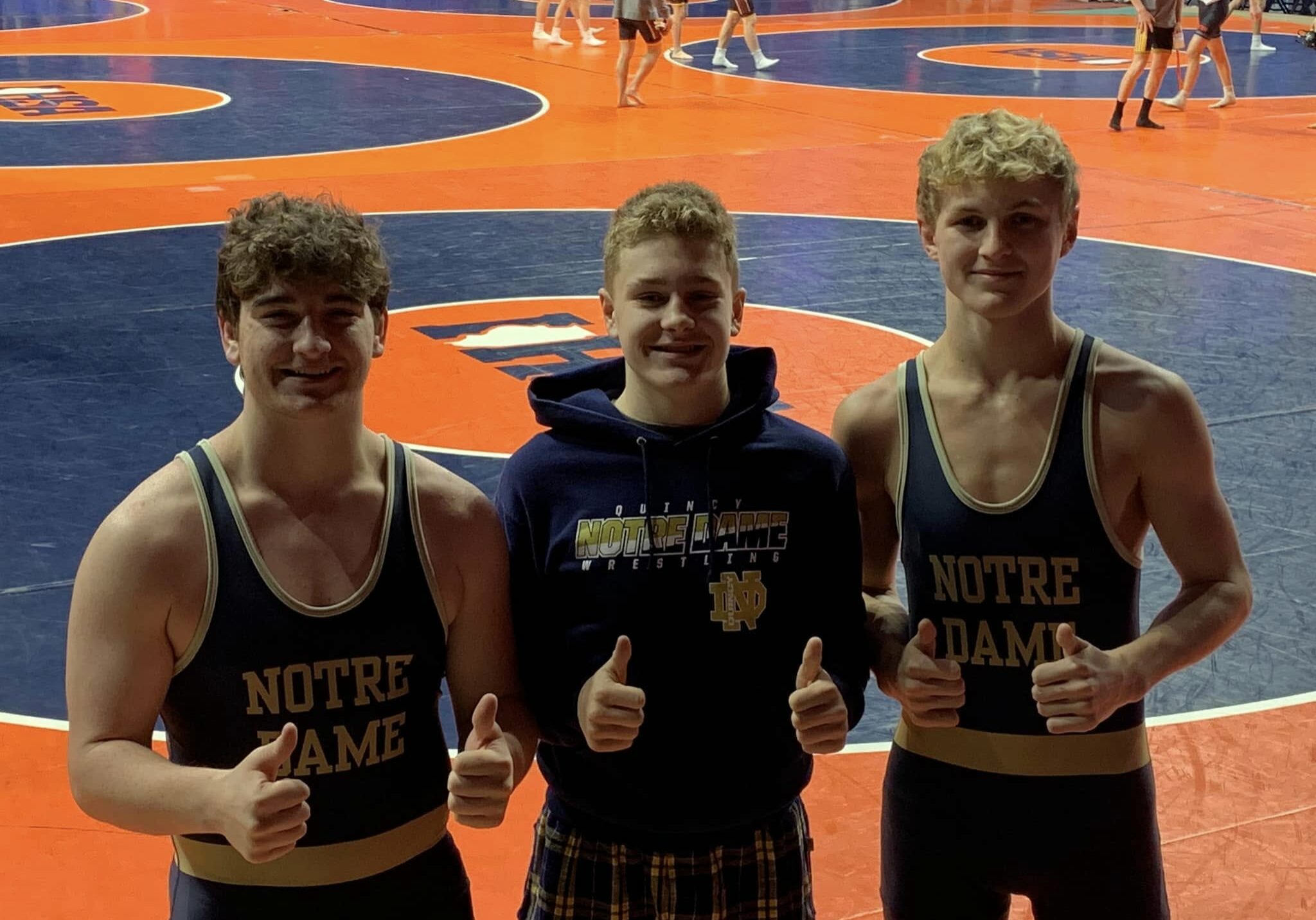 Quincy Notre Dame wrestlers posing for a photo at that Illinois High School Association State Tournament.
