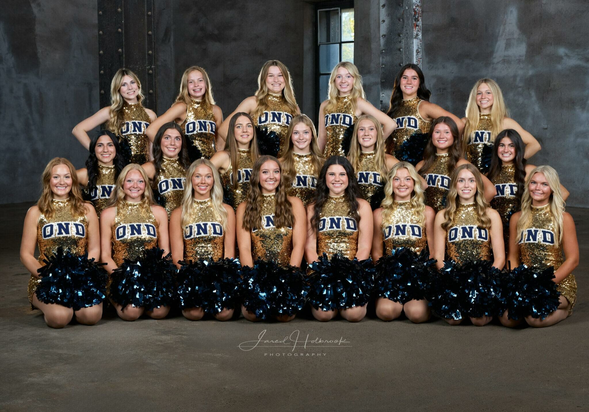 Quincy Notre Dame Pom Pon team posing in matching uniforms for a group photo.